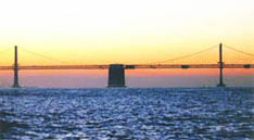 sunset behind bridge